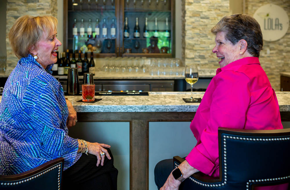 two women sitting at a bar