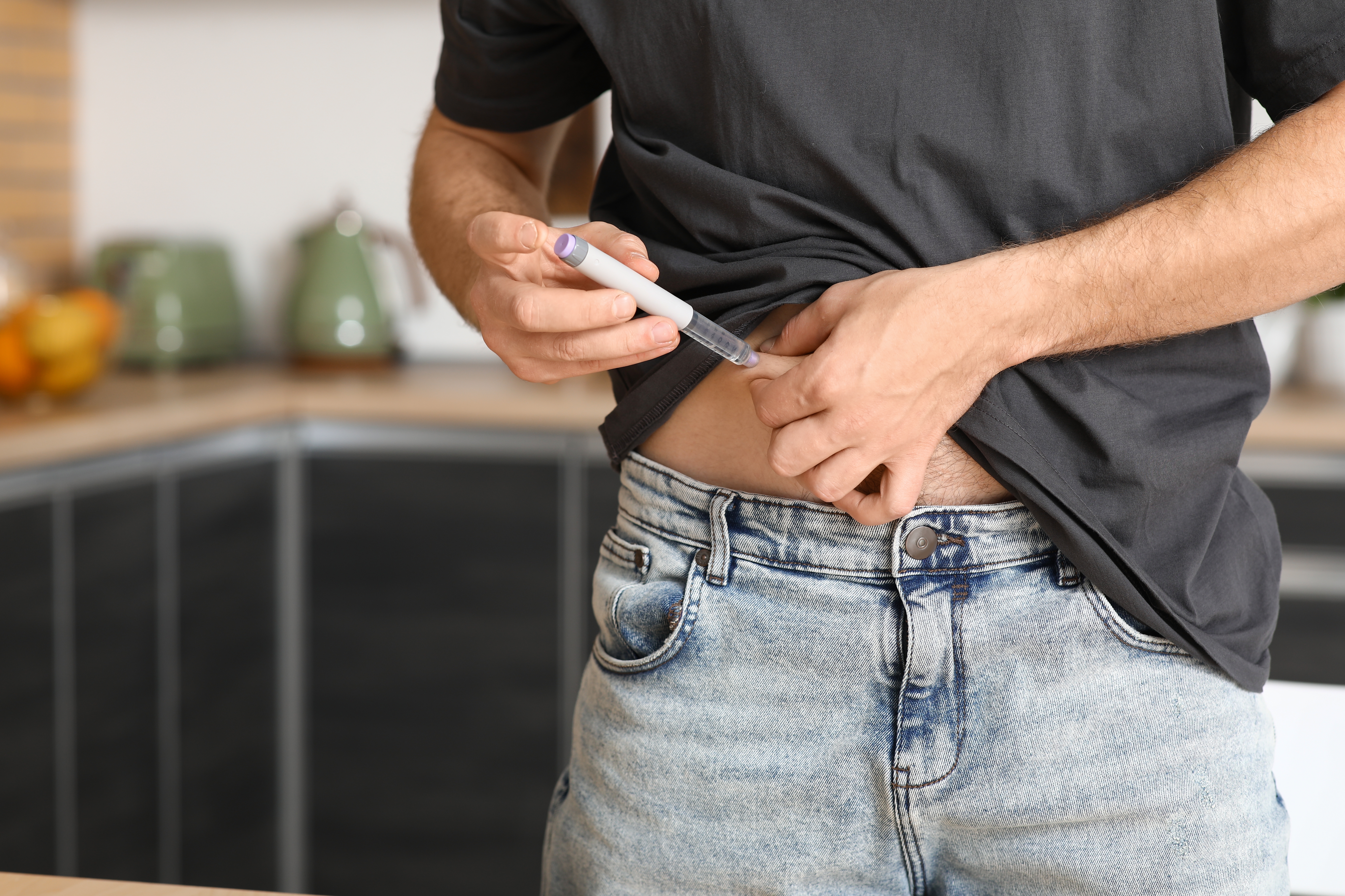 a man injecting insulin into his stomach