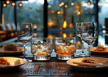 a table with glasses of alcohol and food on it