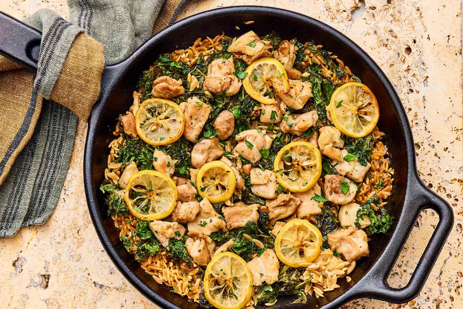 a pan of food with lemon slices