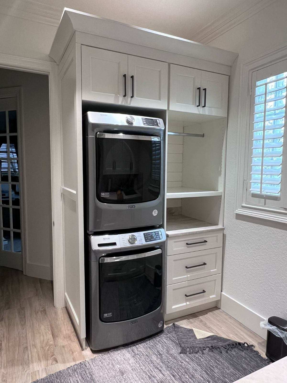 a kitchen with a microwave oven and a shelf