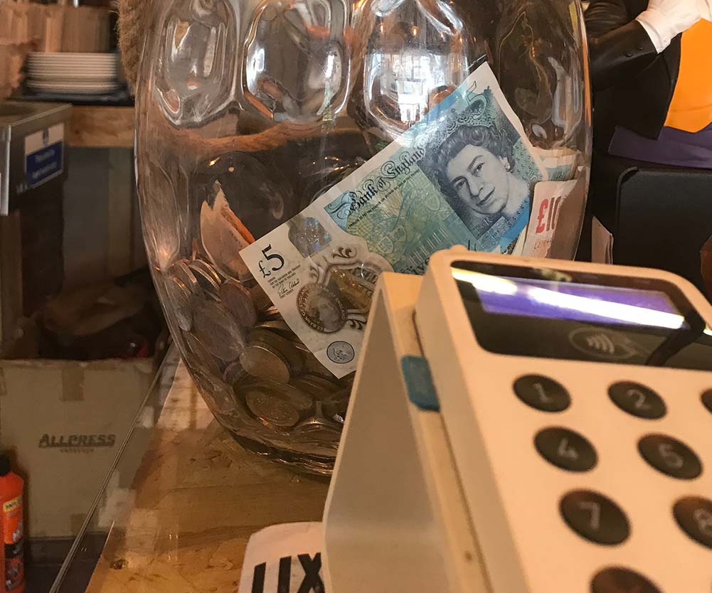 a glass jar with coins and money in it
