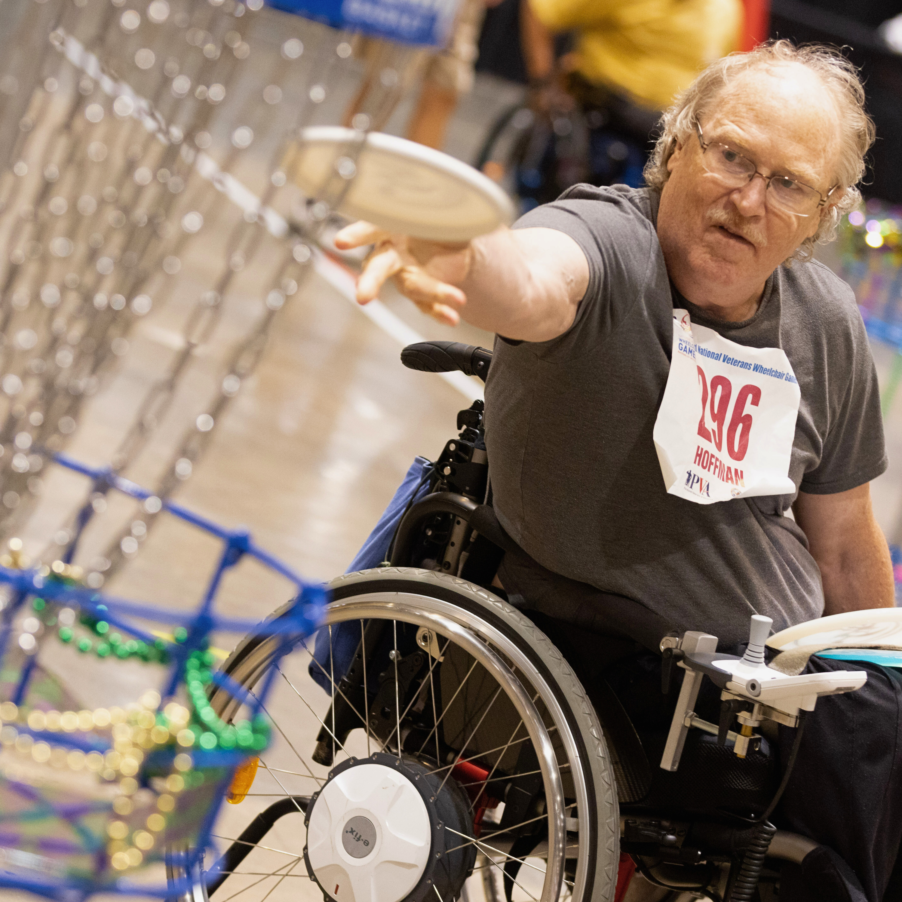 a man in a wheelchair throwing a frisbee