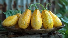 a group of yellow squashes on a plate