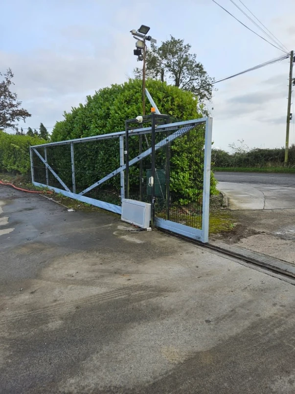 a gate with a fence and a pole