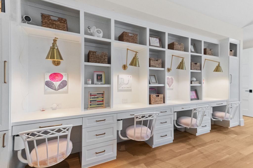 a room with white shelves and desks