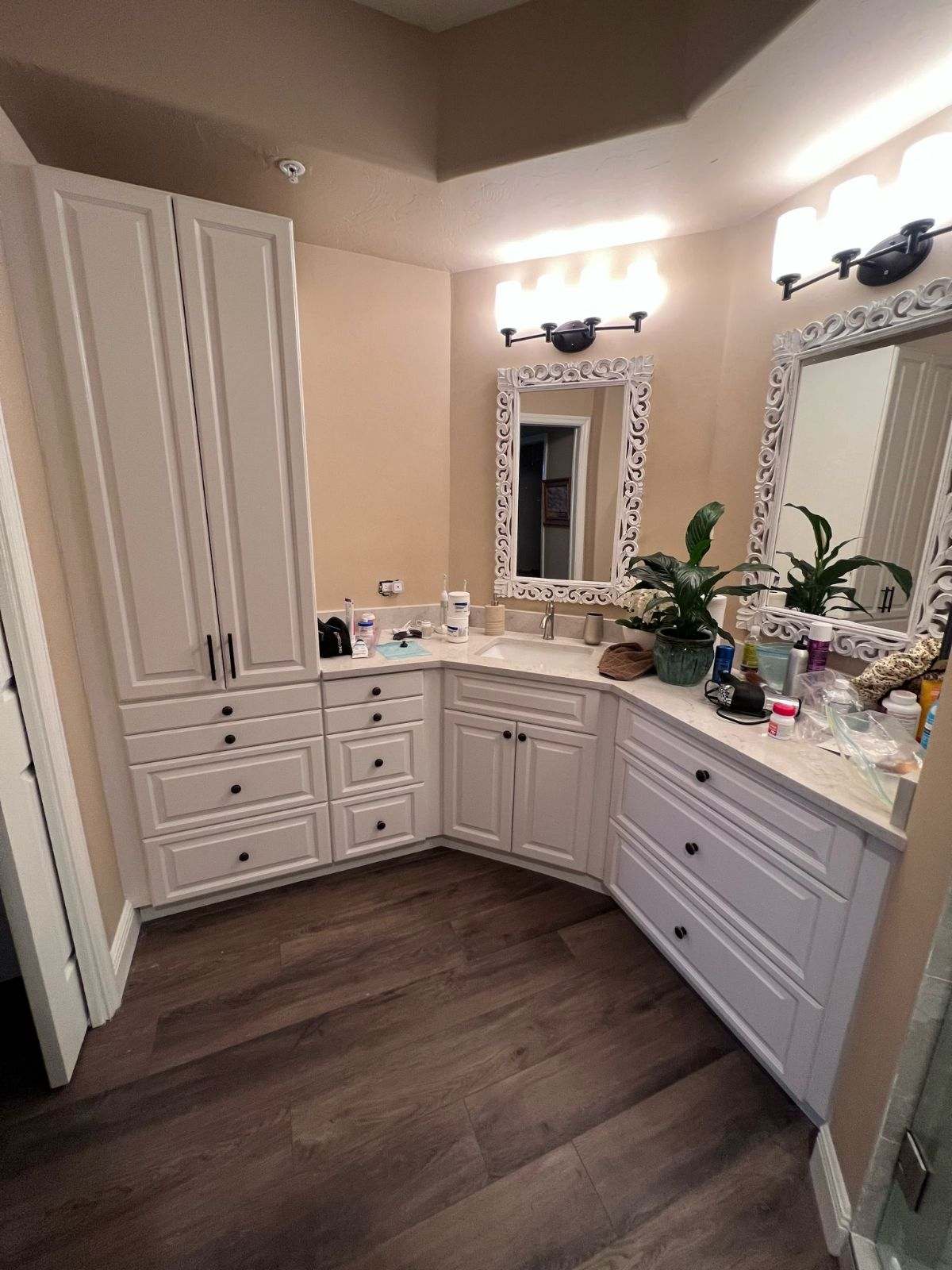 a bathroom with white cabinets and a mirror