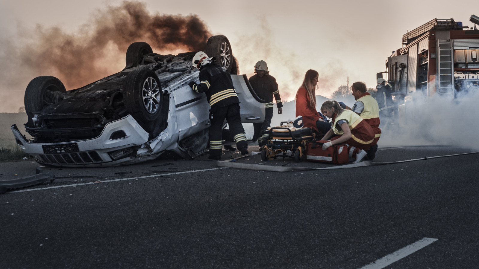 a group of people looking at a wrecked car