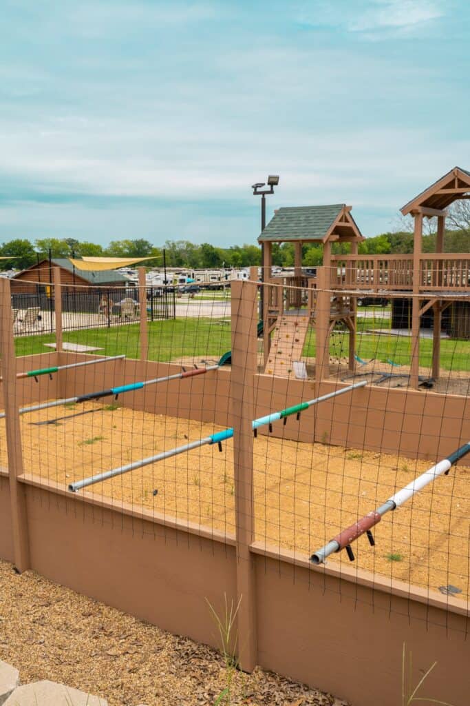 a playground with a fence and a play structure