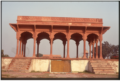 a red building with arches and steps