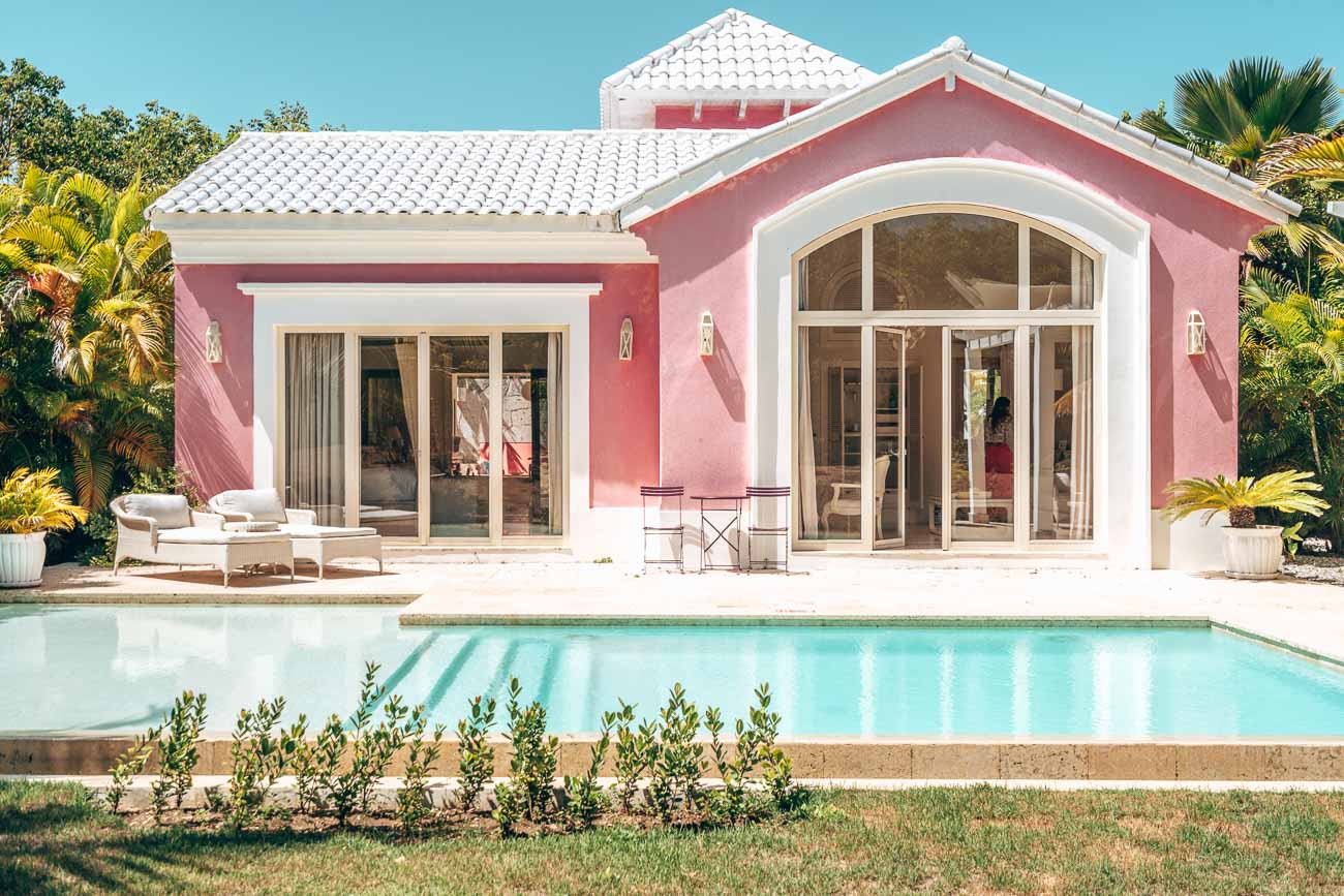 a pink house with a pool