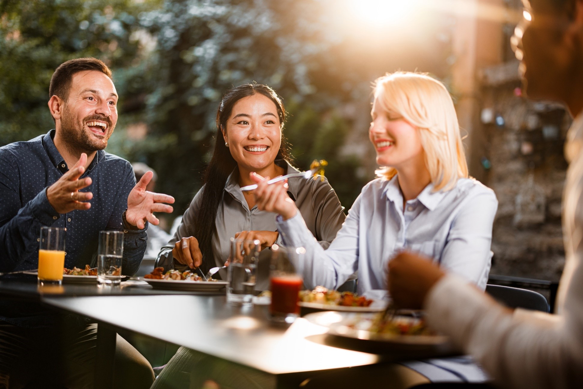 a group of people sitting at a table eating