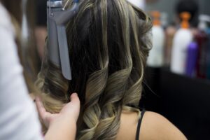 a woman curling her hair