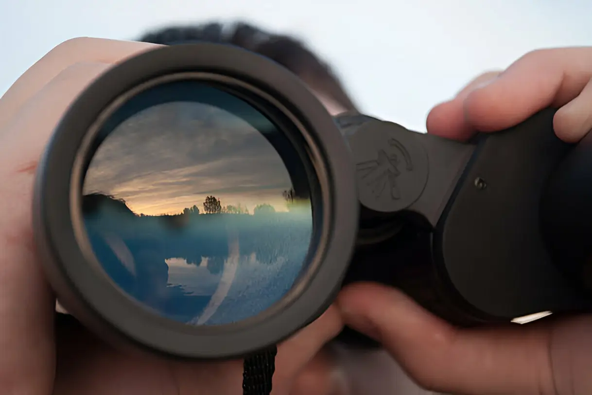a person looking through binoculars