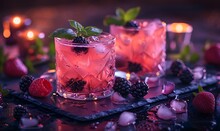 two glasses of pink drink with berries and ice