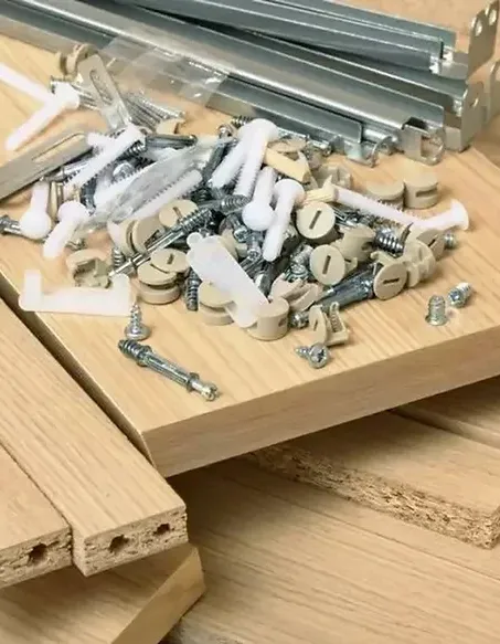 a pile of screws and bolts on a wood surface