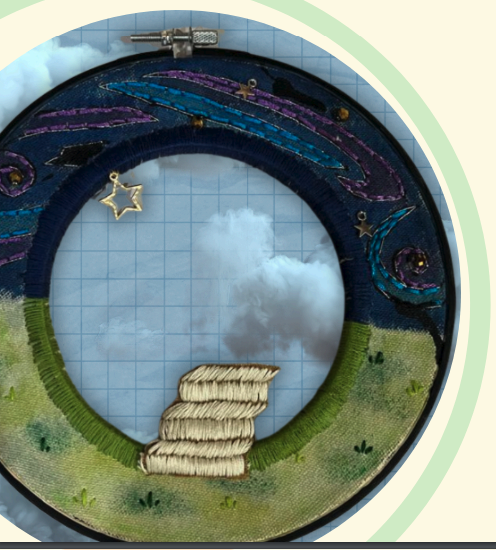 a embroidery hoop with a picture of a landscape
