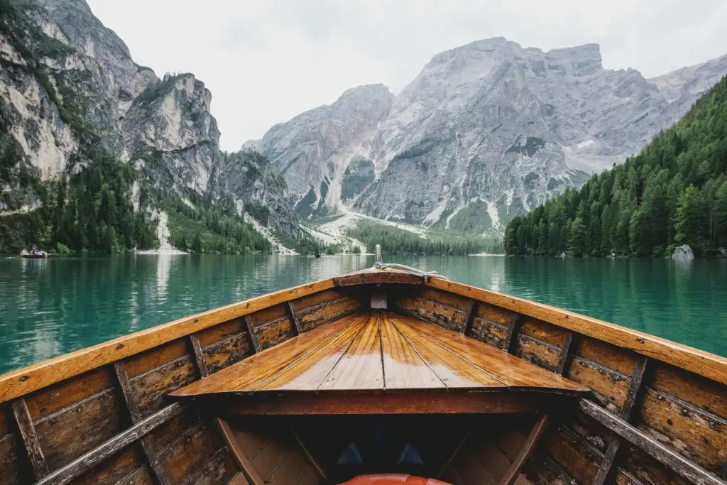 a boat on a lake with mountains in the background