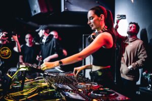 a woman standing at a dj table