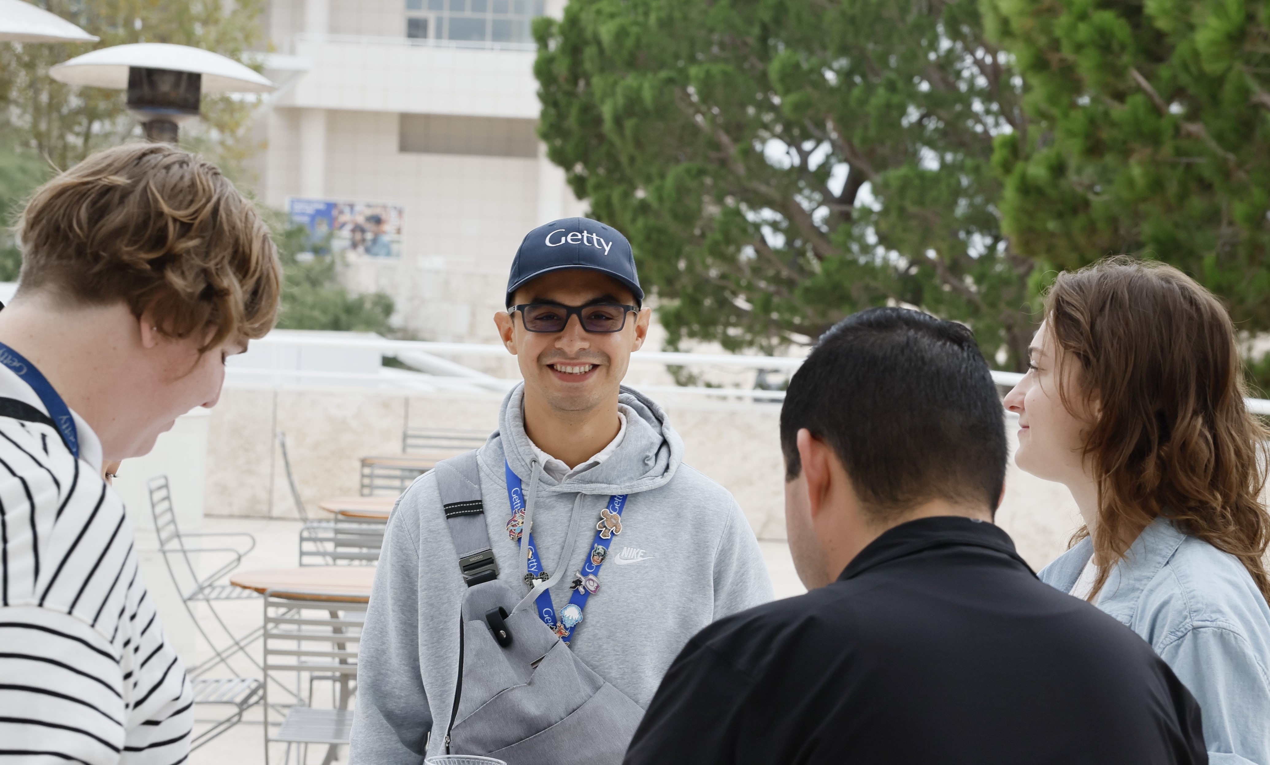 a man wearing a hat and sunglasses smiling