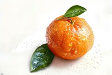 an orange with leaves on a white surface