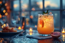 a glass of orange juice with ice and fruit on a table