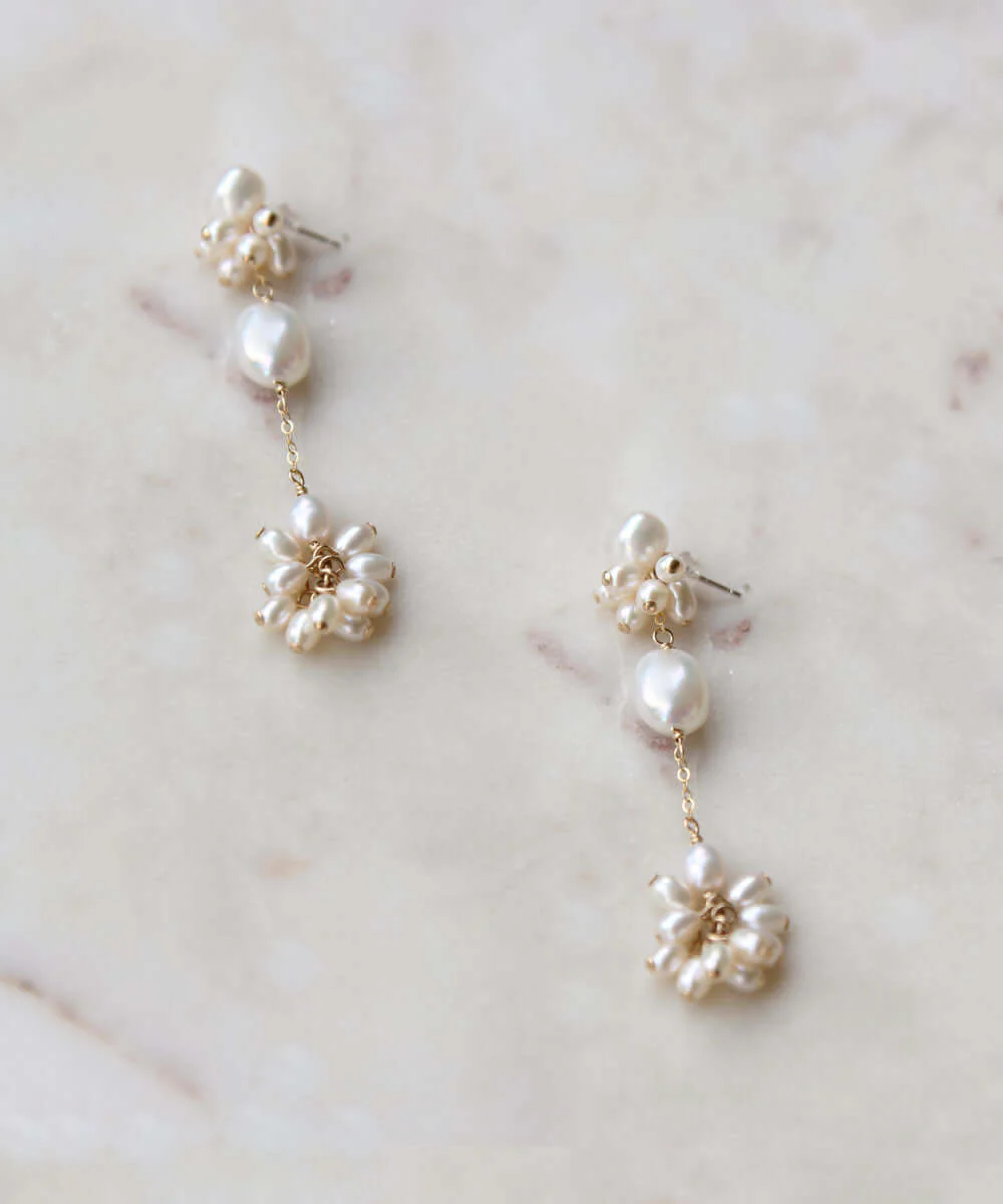 a pair of earrings on a marble surface