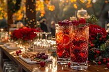 a table with glasses of red liquid and fruit on it