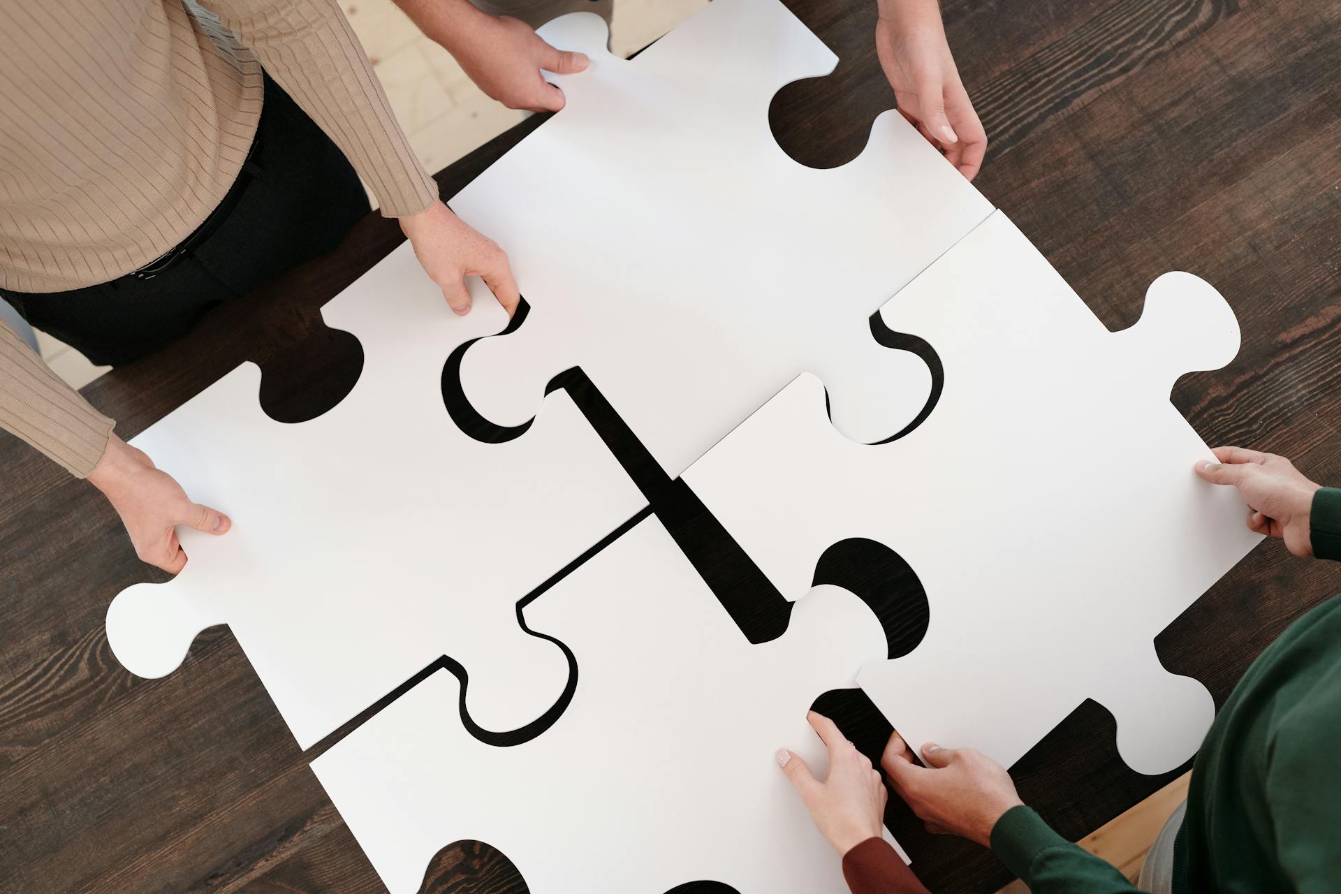 a group of people holding a puzzle