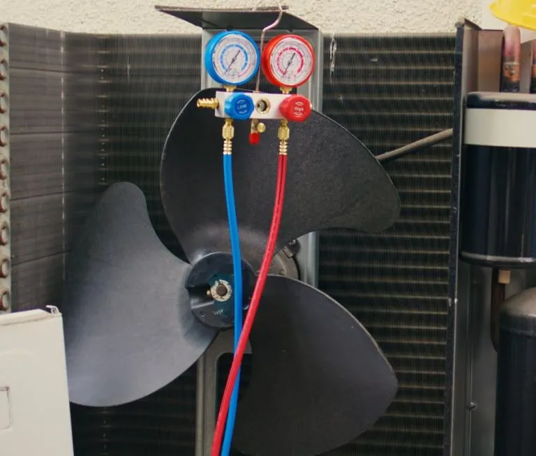 a fan with a couple of gauges and a couple of blue and red tubes