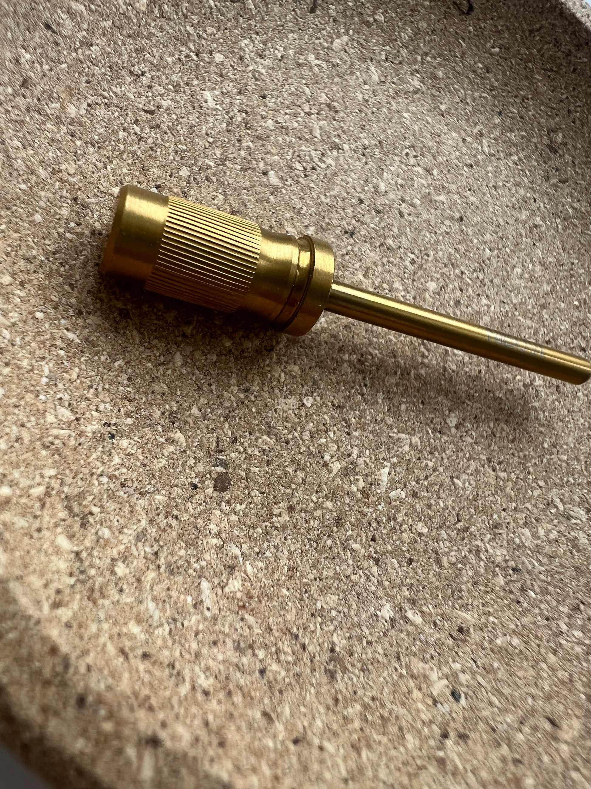 a gold metal tool on a counter