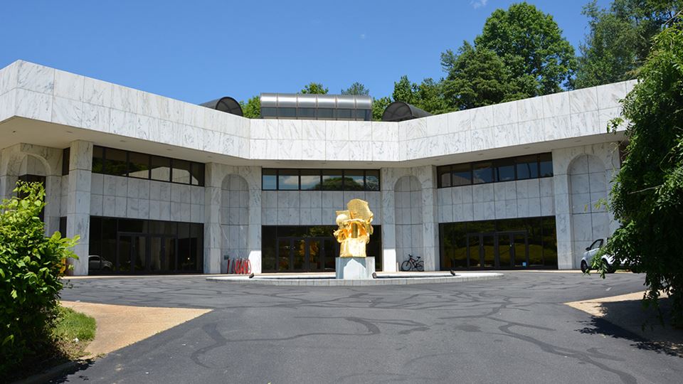 a building with a gold statue in front of it