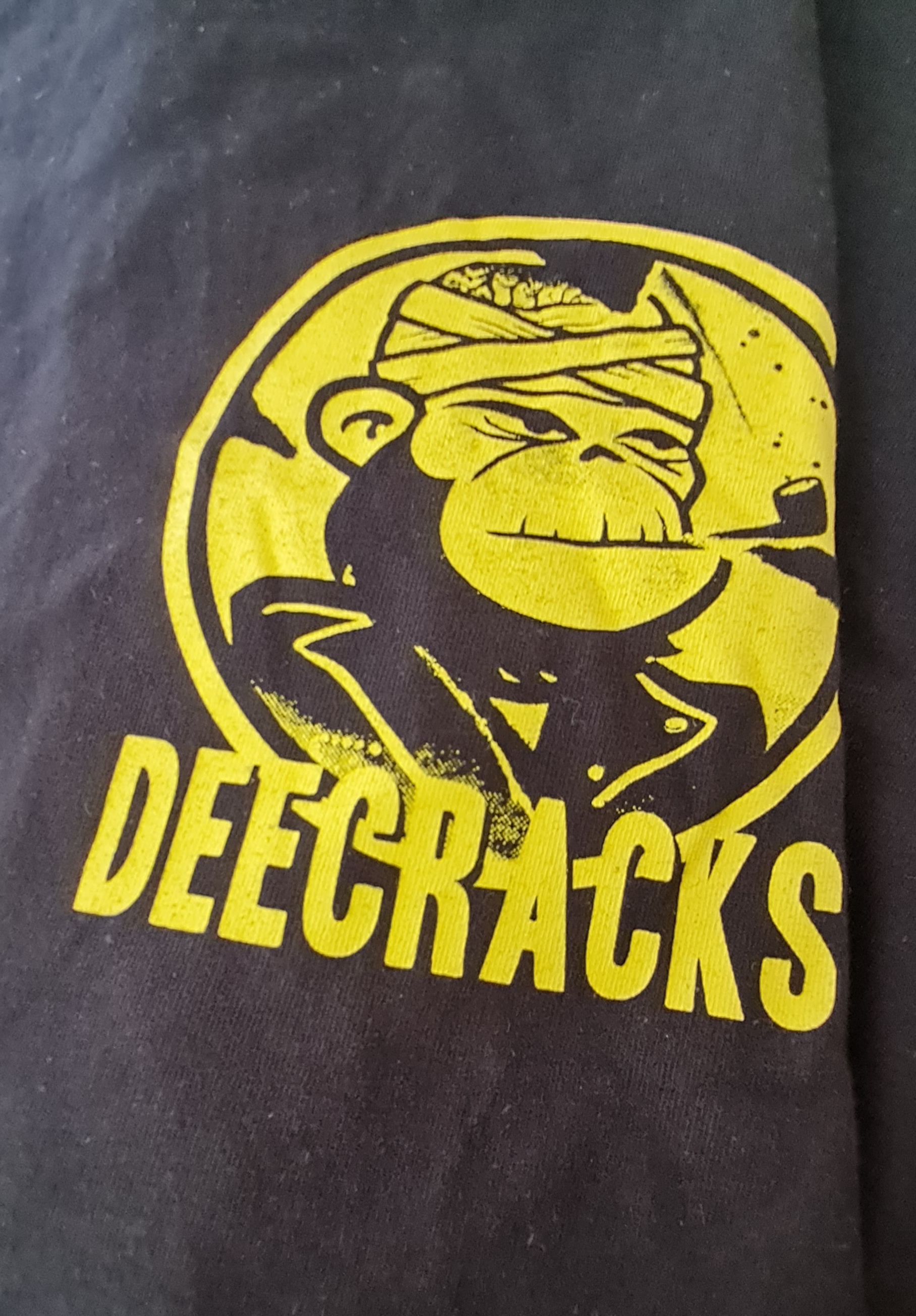 a yellow logo on a black shirt