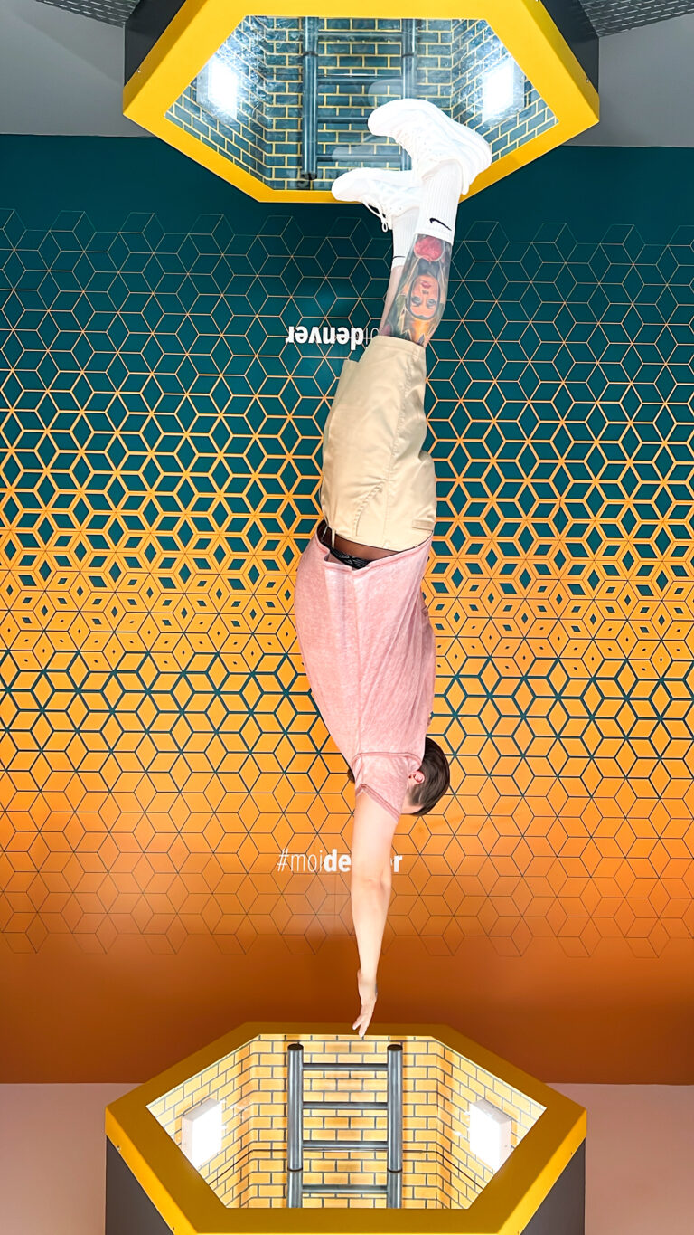 a man doing a handstand on a yellow and blue background