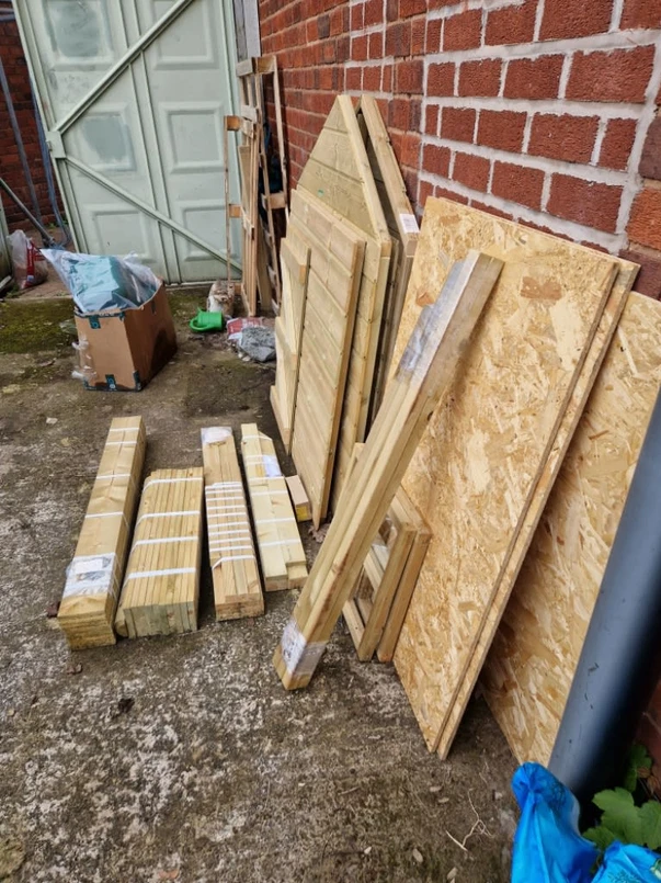 a pile of wood and wood planks