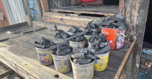 buckets of charcoal on a table