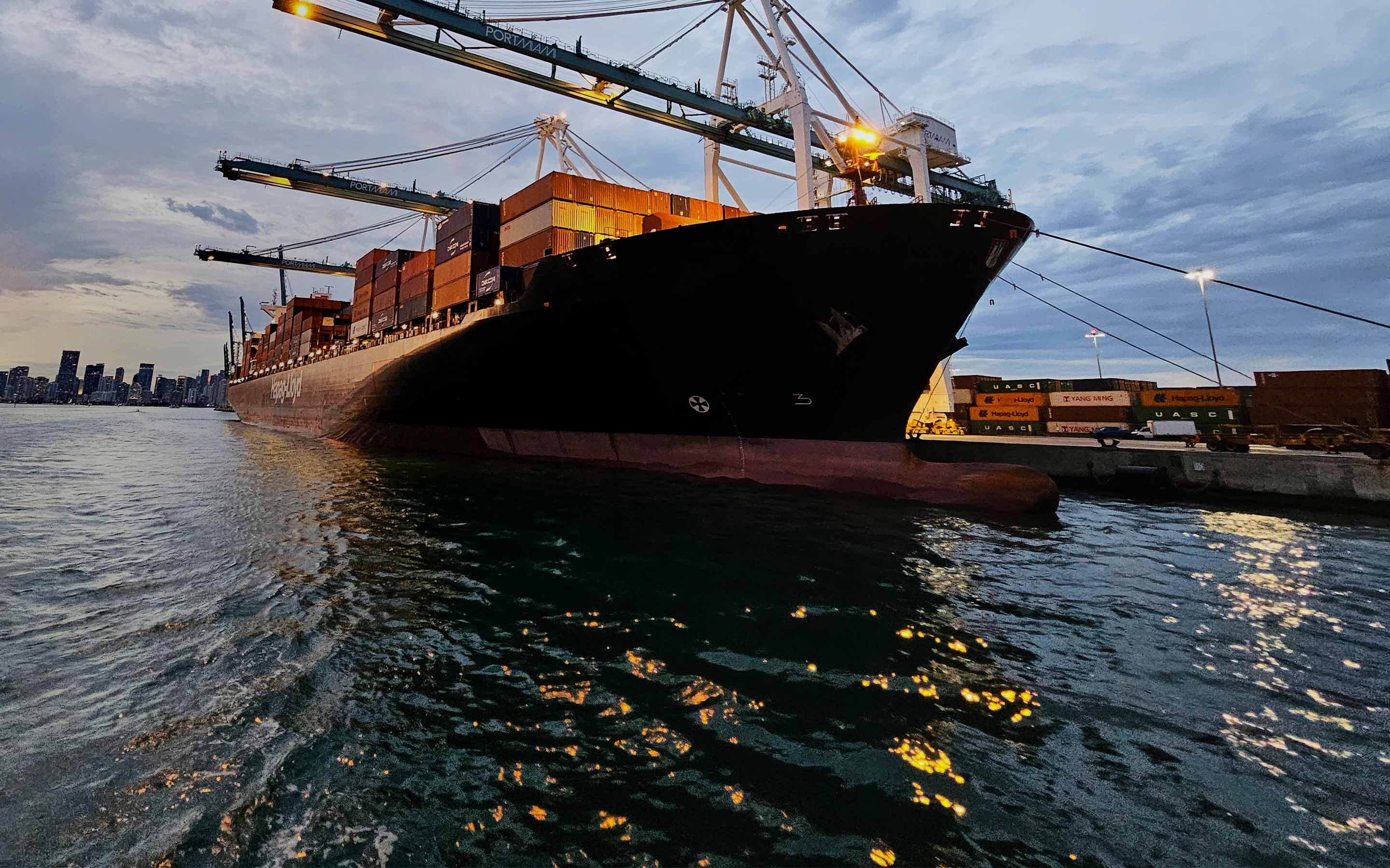 a large ship with containers on the water