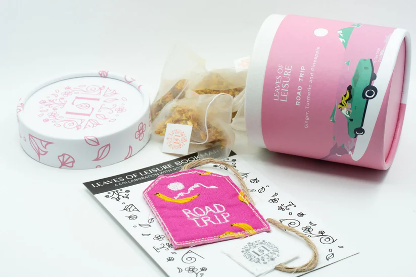 a pink container with a pink tag and a pink package with text