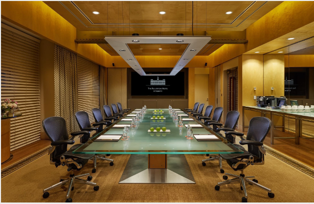a conference room with a glass table and chairs