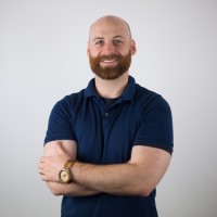 a man with a beard and mustache wearing a blue shirt