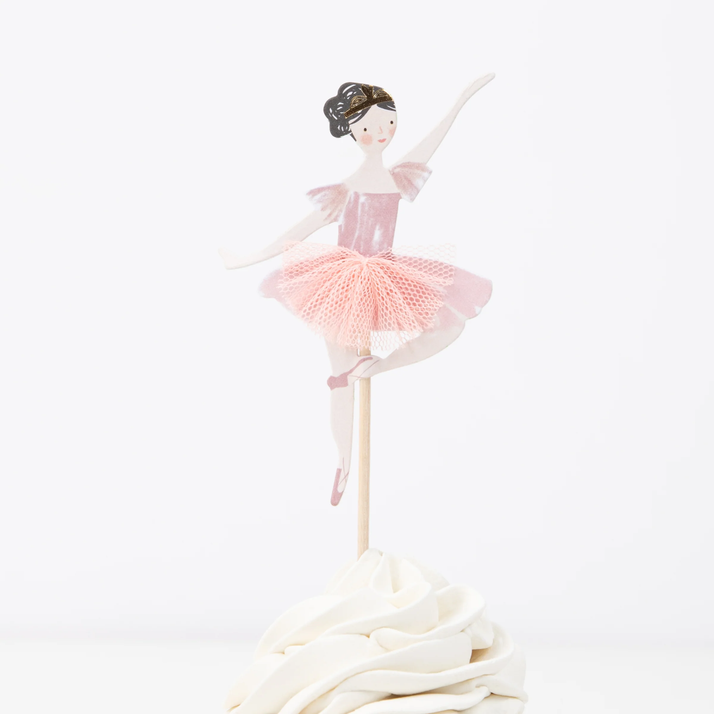 a cupcake with a ballerina figure on top