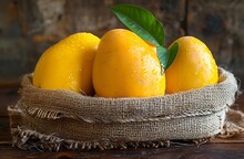 a group of mangoes in a burlap basket