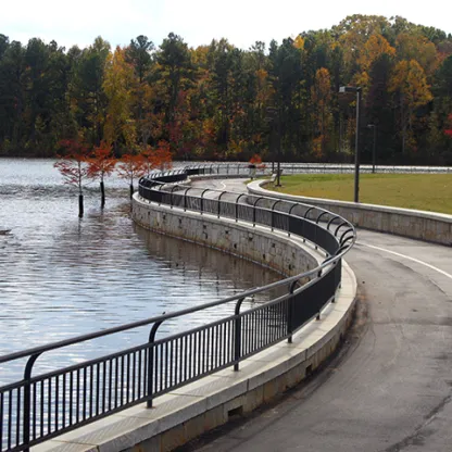 a road with railings and water