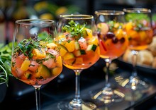 a row of wine glasses filled with fruit