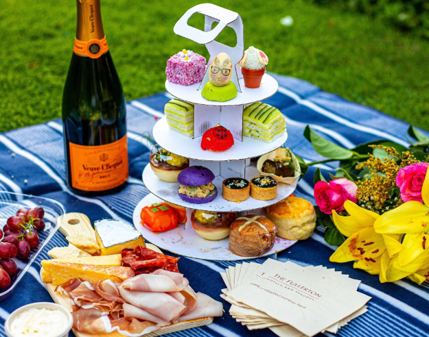 a picnic blanket with food and drinks