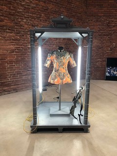 a mannequin in a glass case