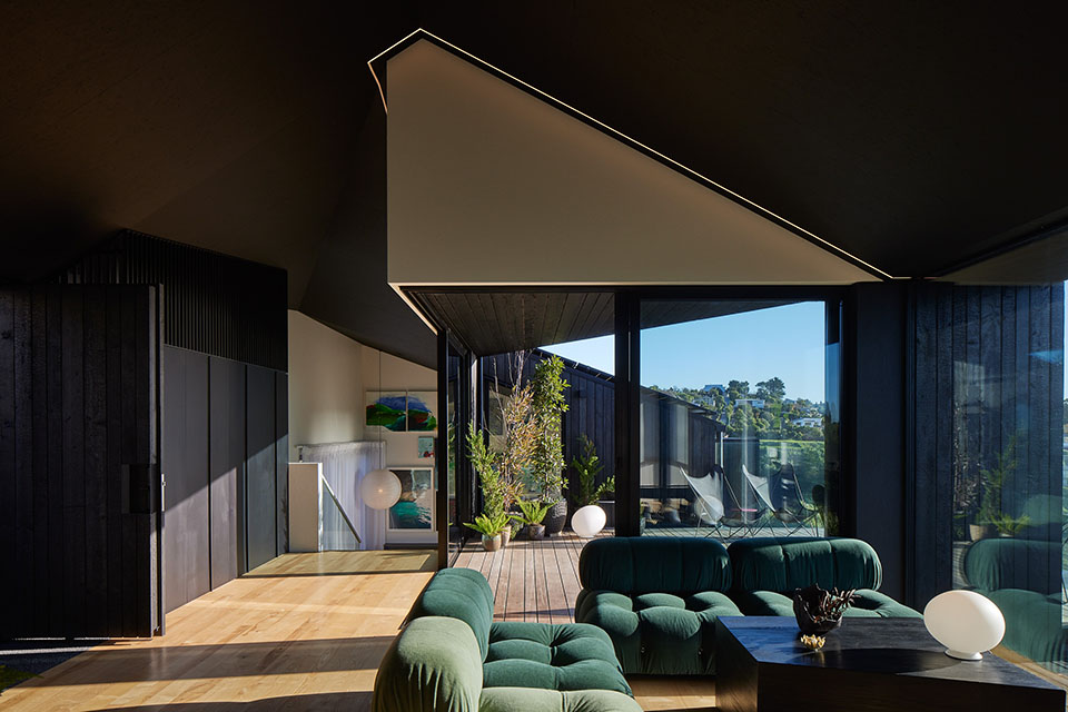 a living room with a green couch and a black table