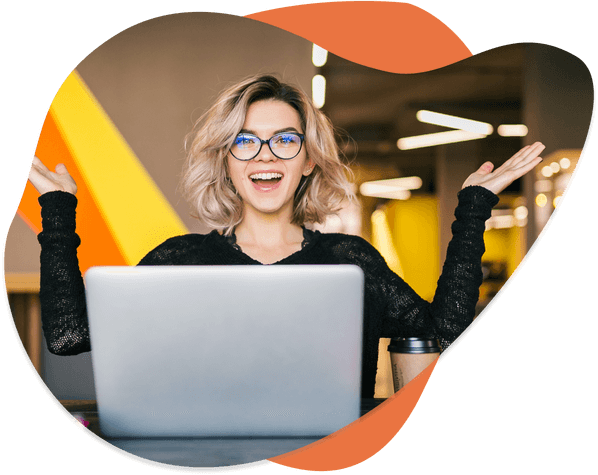 a woman with her arms raised in front of a laptop