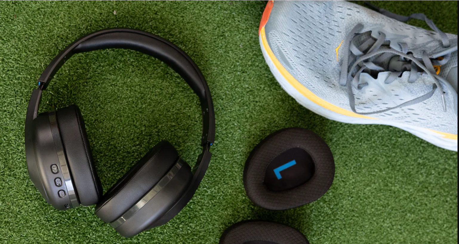 a pair of shoes and headphones on a green surface