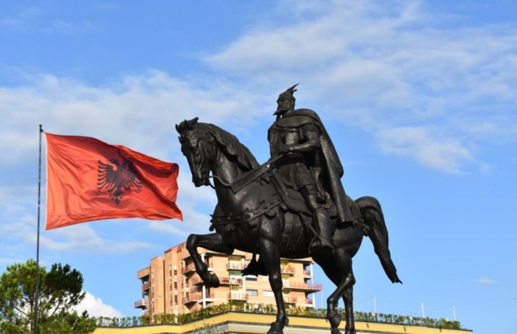 a statue of a man on a horse with a flag